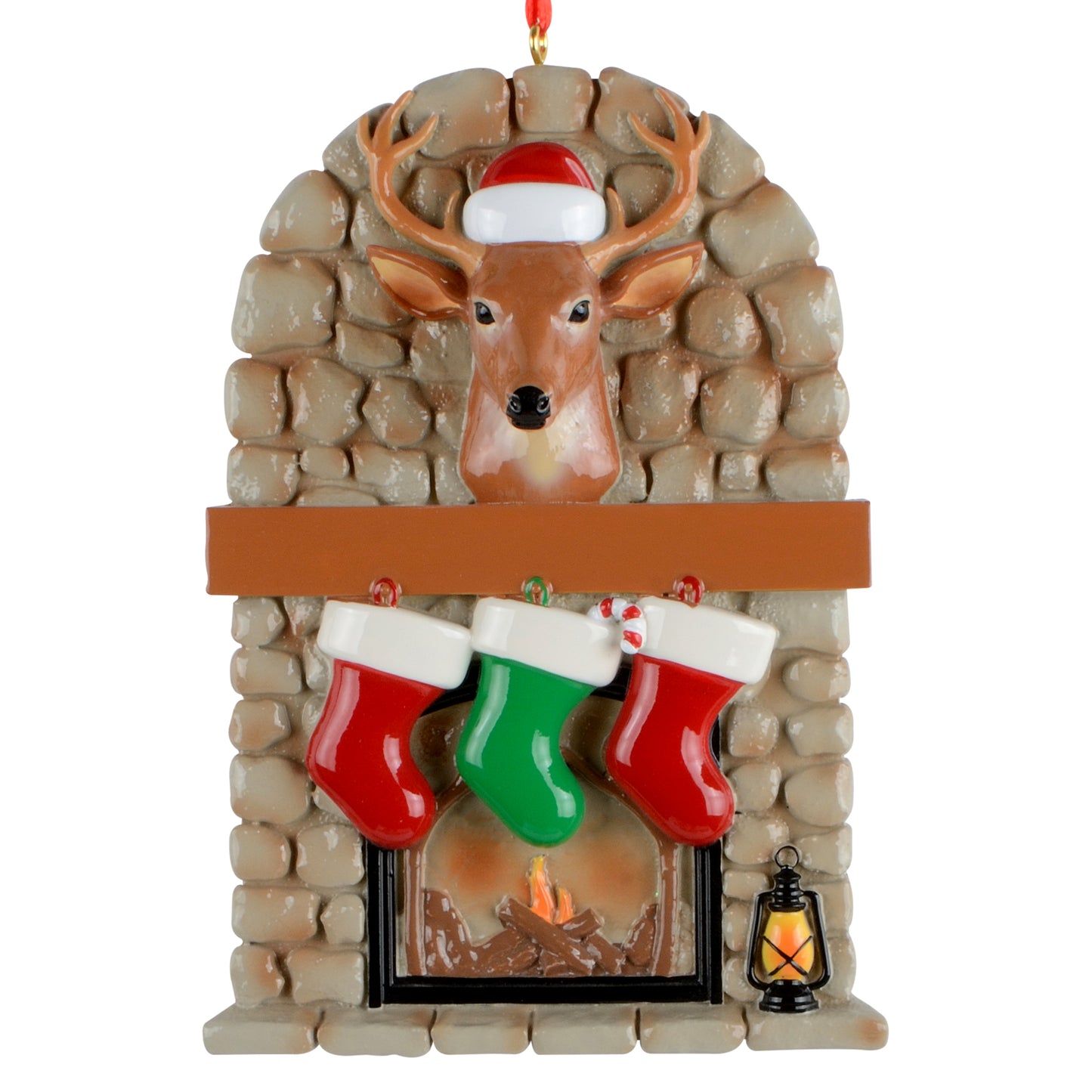 Handpainted Christmas ornament featuring a stone fireplace with a deer head wearing a Santa hat, three hanging stockings, and a lantern.