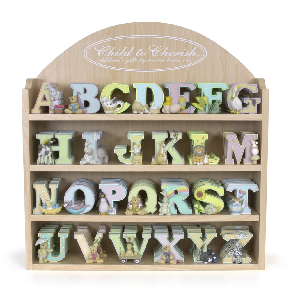 Wooden alphabet letters with colorful pastel paint and animal figures displayed on a natural wood shelf