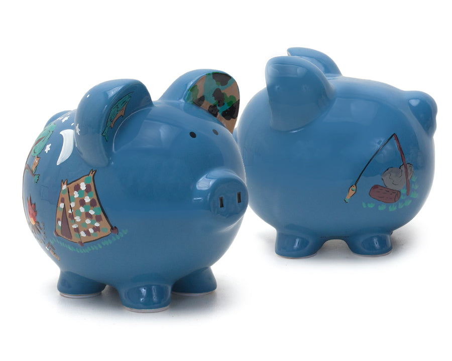 Two blue piggy banks side by side showing handpainted camping scenes from different angles