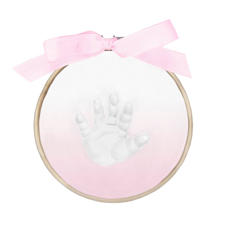 Finished Ombre Claydough handprint in wooden ring with pink ombré paint and tied pink ribbon bow