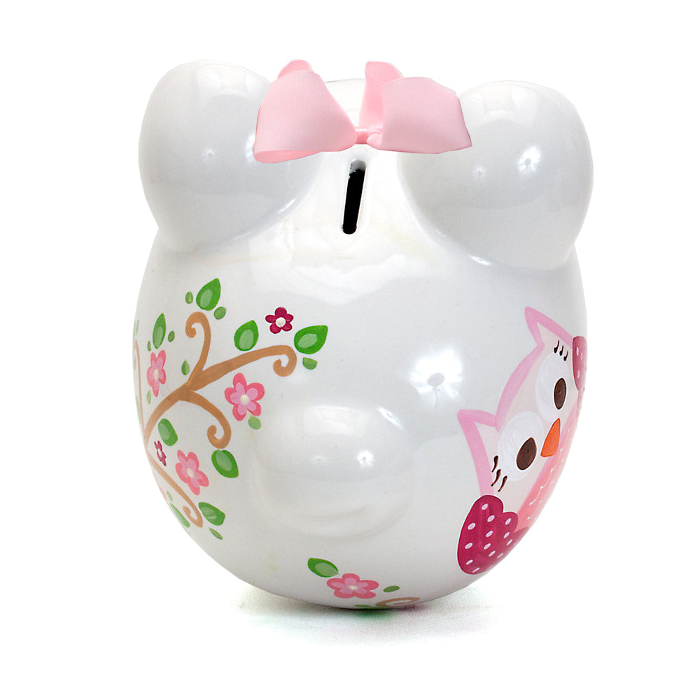 Top view of white piggy bank with pink bow and floral accents