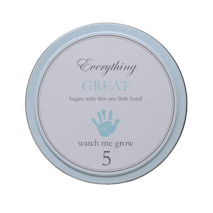 Top view of blue tin numbered 5 with handprint and 'watch me grow'