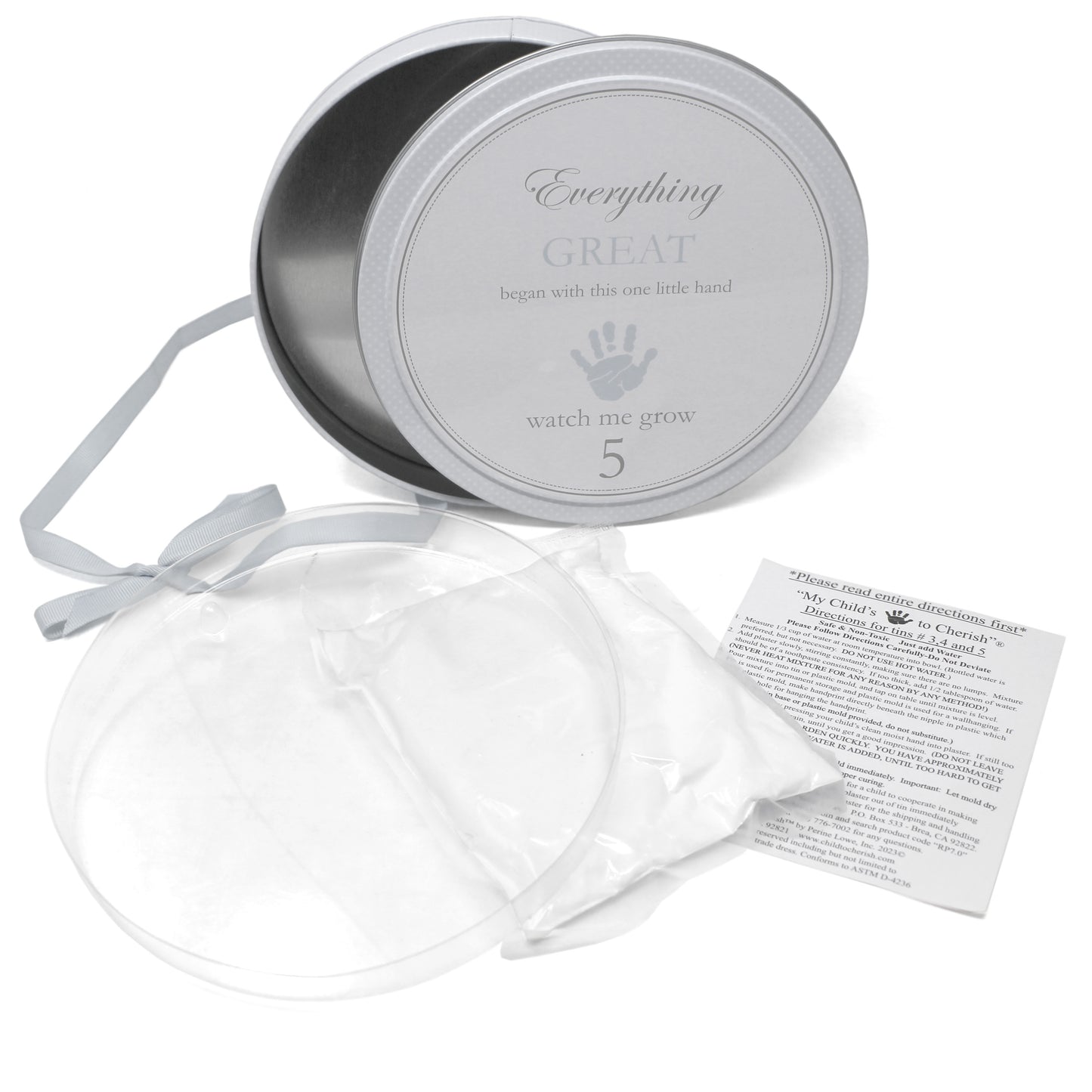 Open gray handprint tin showing plaster mold and instruction sheet inside