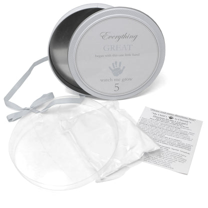 Open gray handprint tin showing plaster mold and instruction sheet inside