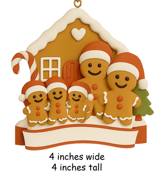 Handpainted gingerbread family ornament with five members wearing Santa hats in front of a gingerbread house with candy cane and blank banner