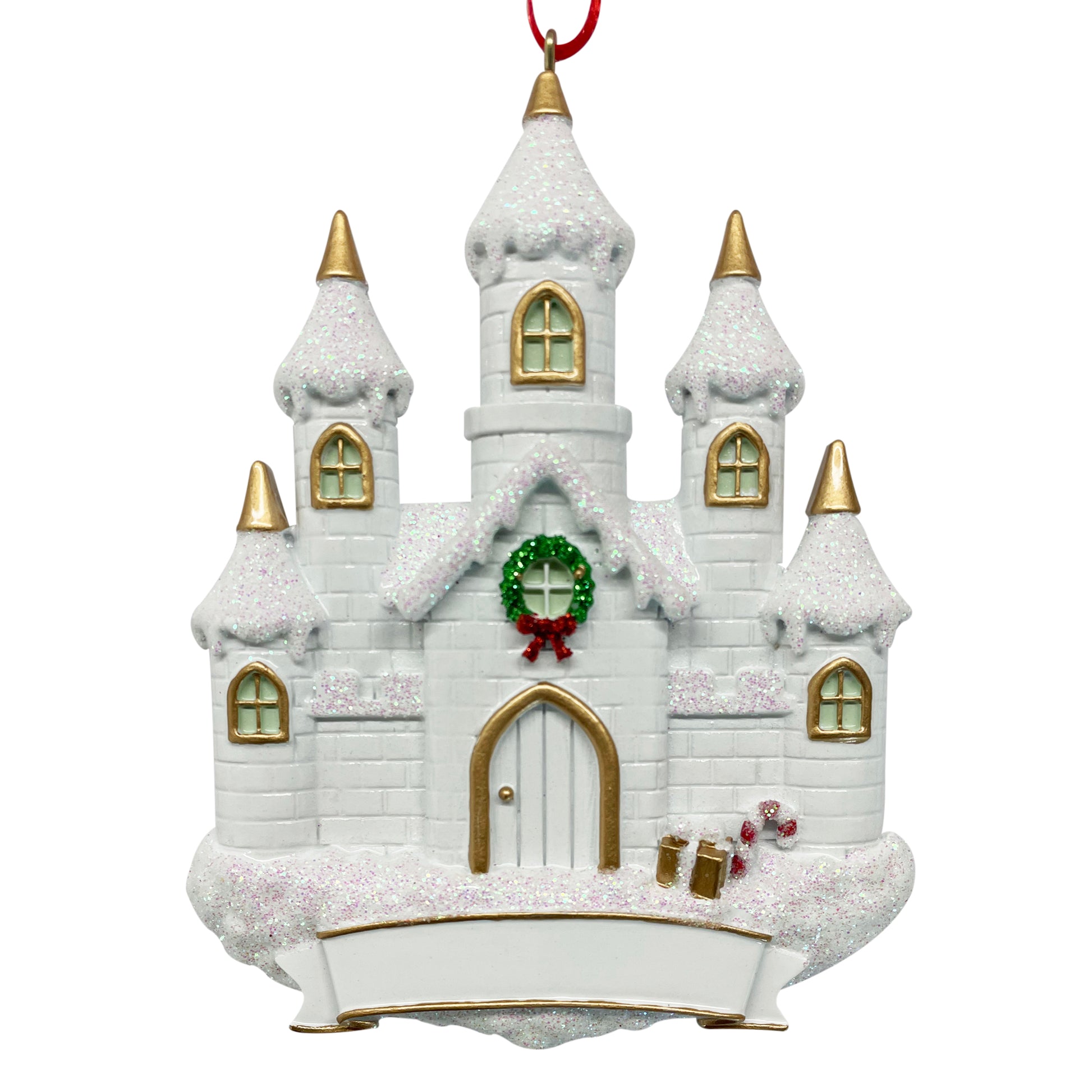White castle holiday ornament with snow-covered roof, gold-trimmed windows, green wreath with red bow, candy canes, and blank banner