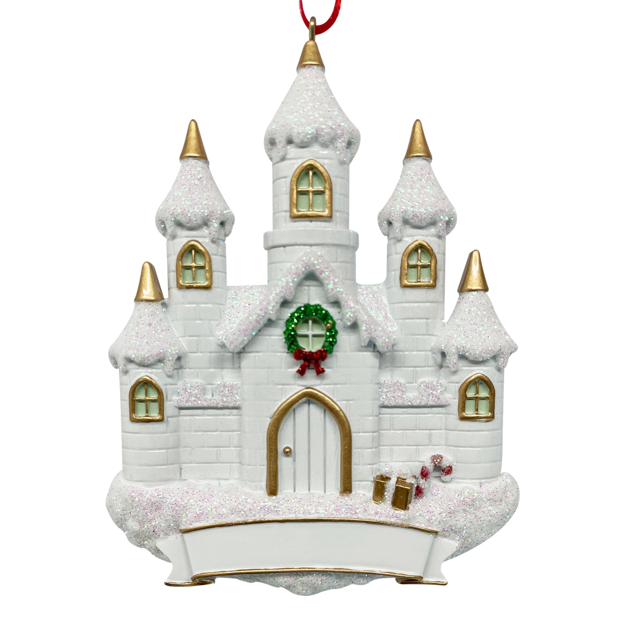 White castle holiday ornament with snow-covered roof, gold-trimmed windows, green wreath with red bow, candy canes, and blank banner