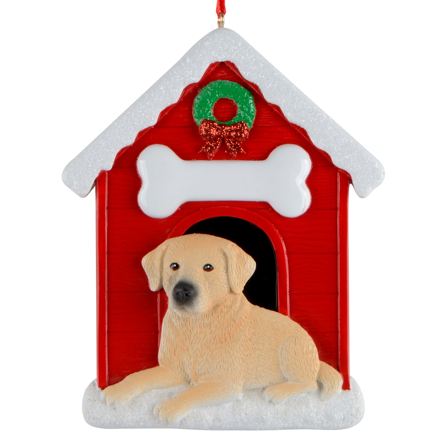 Yellow Labrador dog lying in front of a red doghouse with a white bone and green wreath Christmas ornament