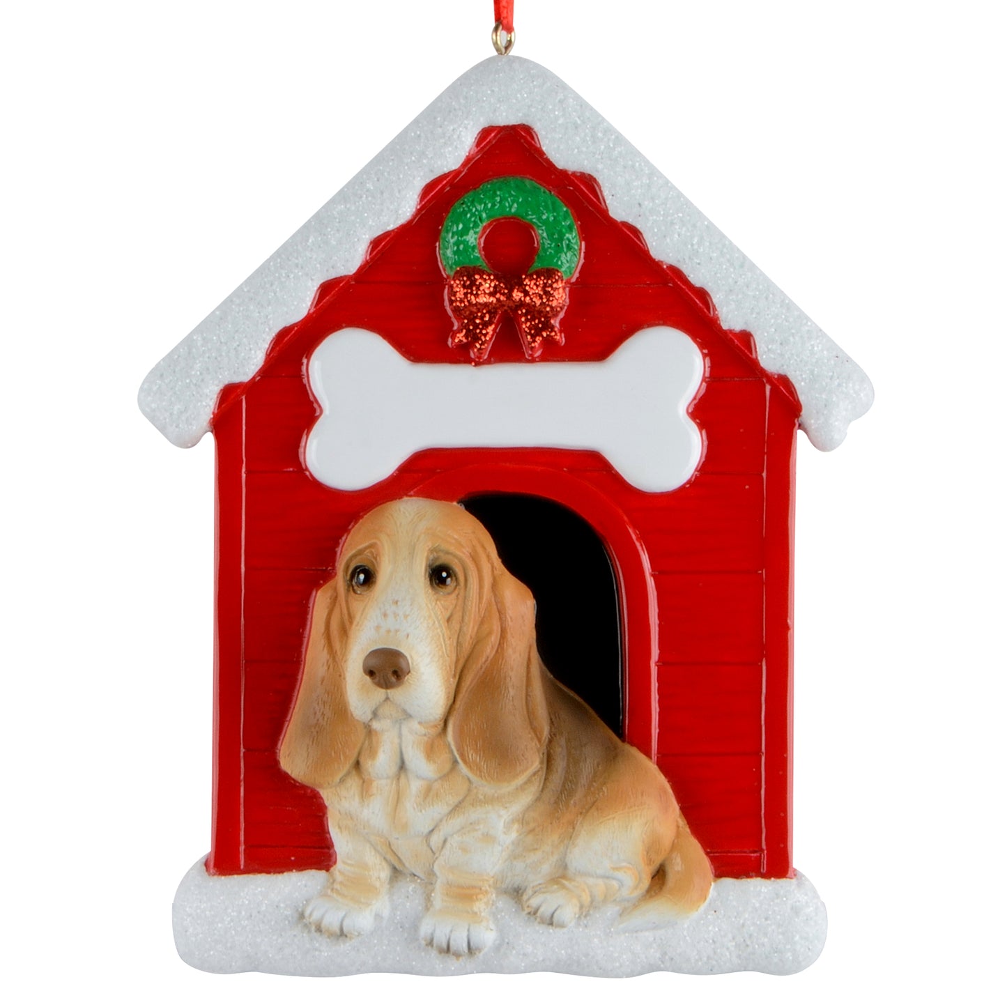 Handpainted Basset Hound sitting in snowy red doghouse ornament with glitter accents and holiday wreath