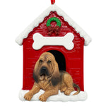 Handpainted Bloodhound dog lying in front of red doghouse Christmas ornament with snowy roof and wreath