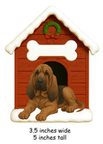 Illustrated Bloodhound doghouse ornament measuring 3.5 inches wide and 5 inches tall with red doghouse and white snowy roof