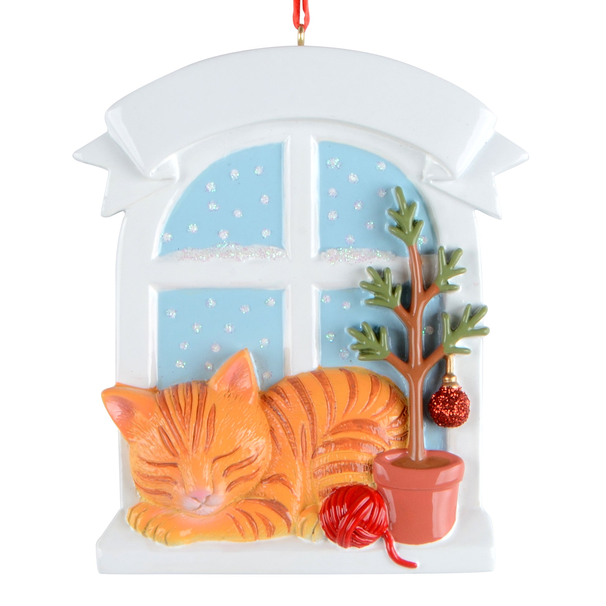Orange tabby cat sleeping by window with potted tree and yarn ball holiday ornament