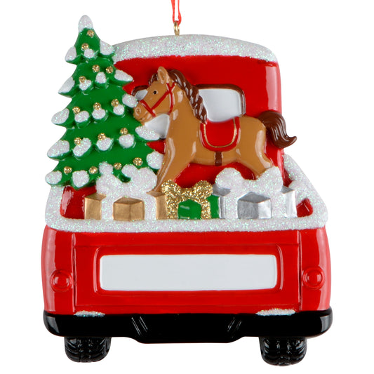 Rear view of red truck Christmas ornament with presents, rocking horse, glitter snow, and decorated tree