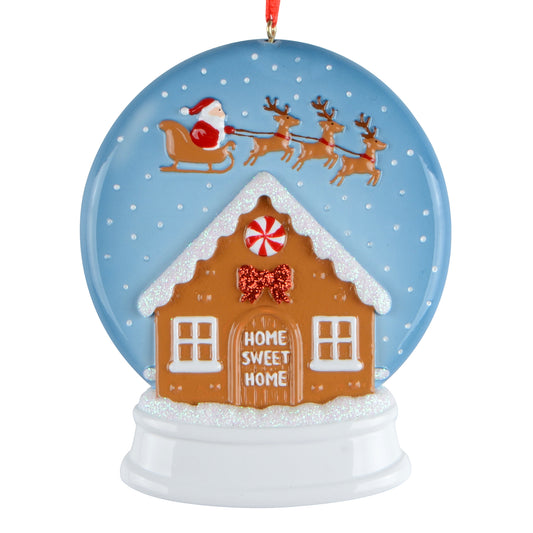 Handpainted Home Sweet Home snowglobe ornament with Santa Claus and reindeer flying over a gingerbread house