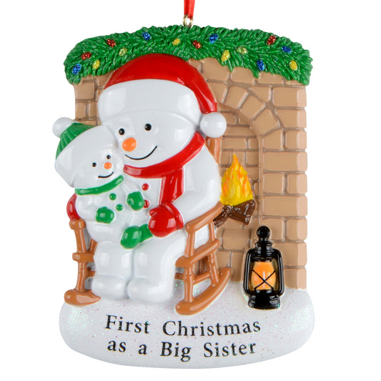 Handpainted snowman ornament of big sister and little snowman in rocking chair by fireplace with holiday lights garland