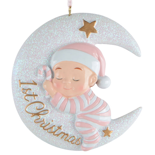 Sleeping baby in pink and white pajamas on glittering crescent moon with stars and '1st Christmas' text