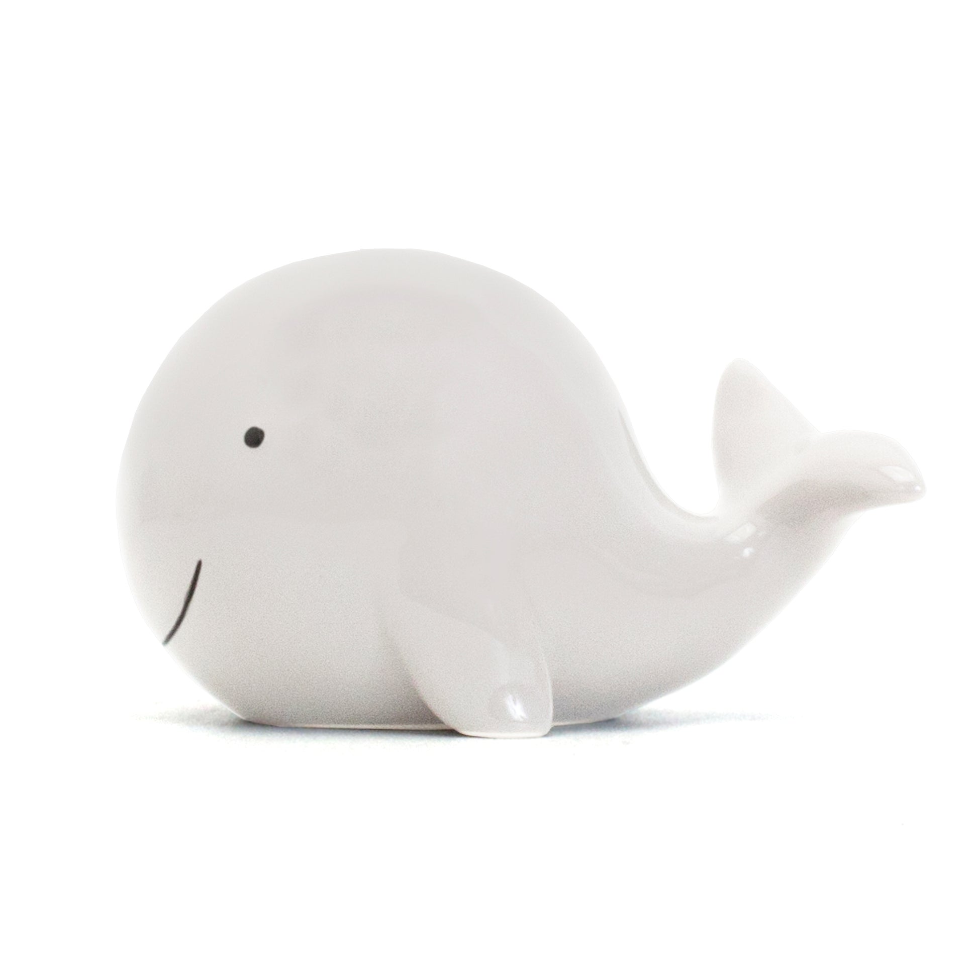 Bottom view of whale piggy bank revealing coin slot and rubber stopper