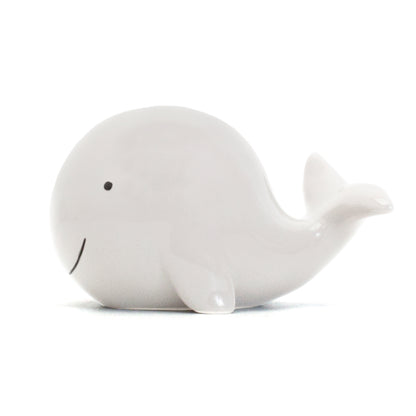 Bottom view of whale piggy bank revealing coin slot and rubber stopper