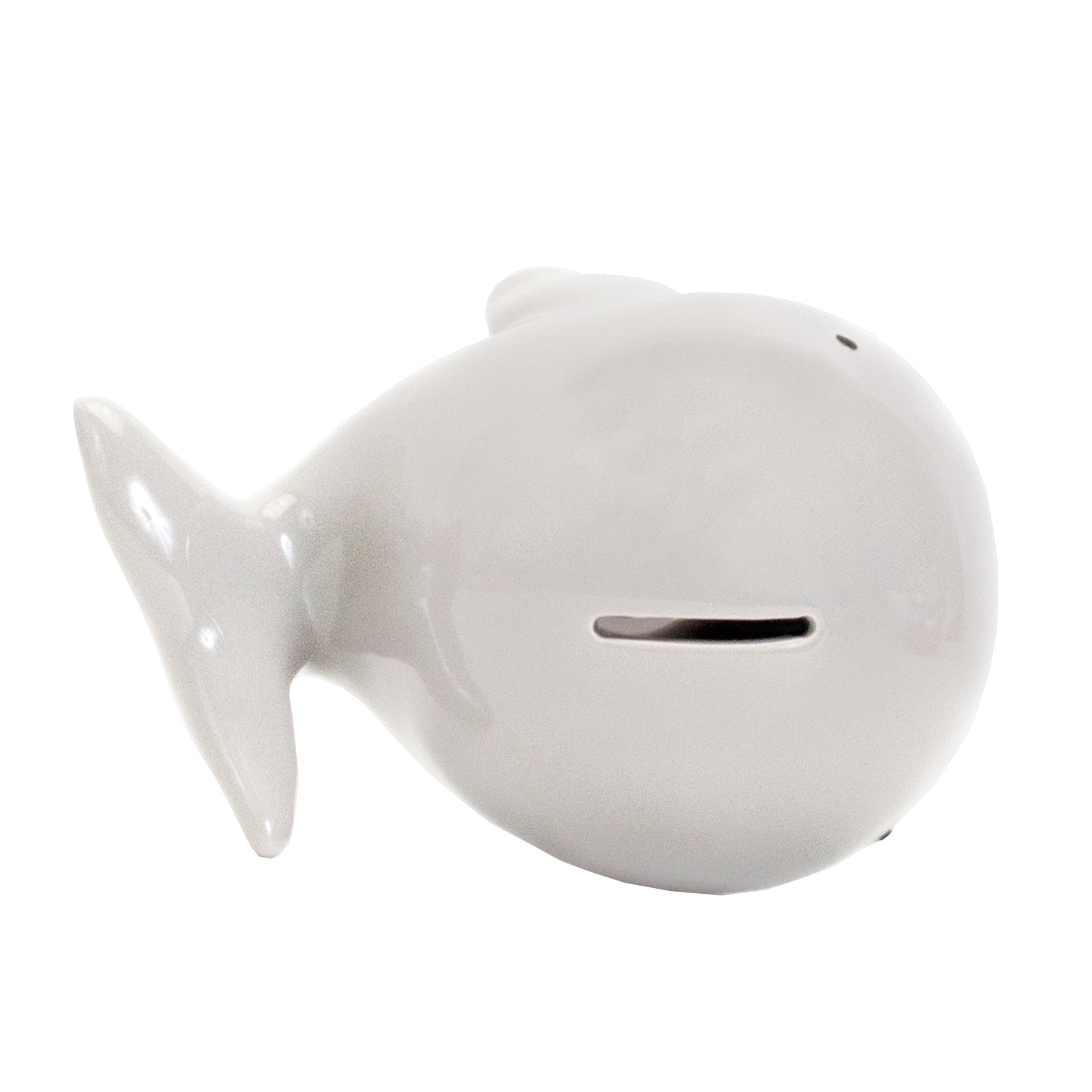 White whale piggy bank placed on shelf with toys and wicker basket nearby