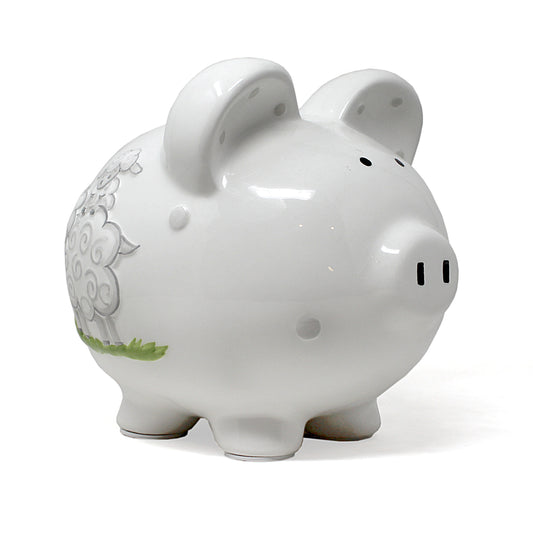 White ceramic piggy bank with gray lamb illustration on side, viewed from front left