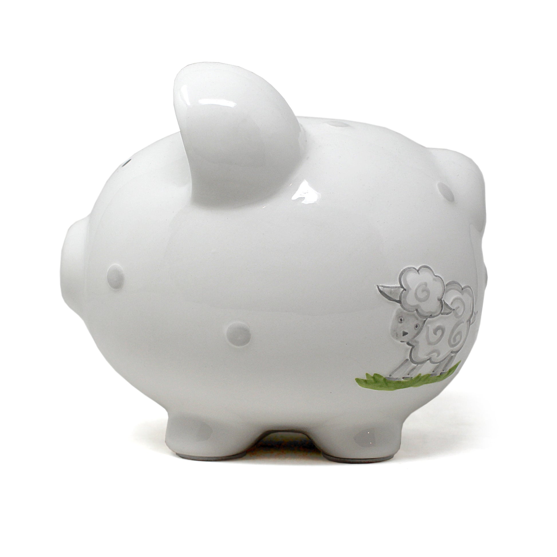 Side view of white ceramic piggy bank featuring two gray lambs and green grass