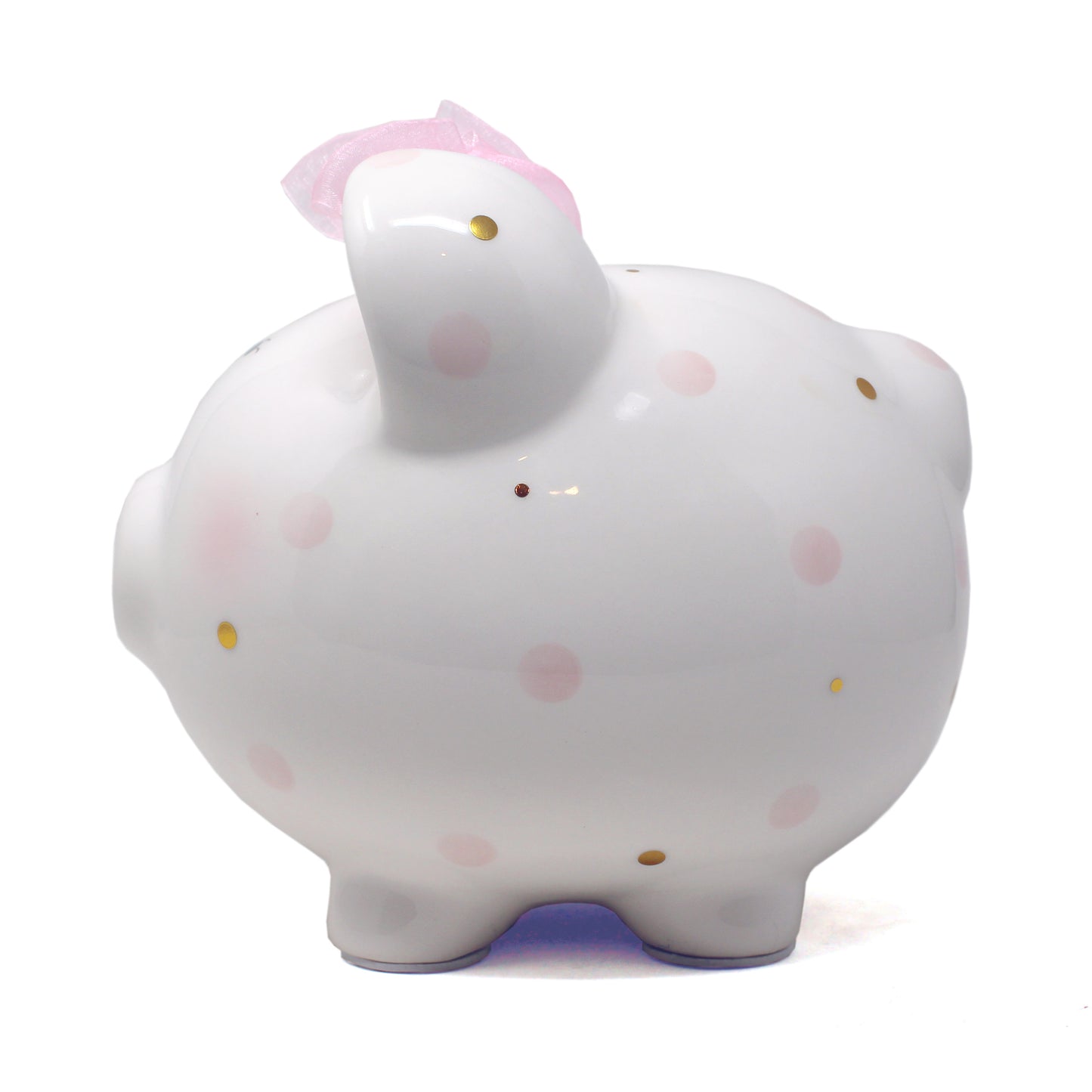 White ceramic piggy bank with pink polka dots and pink ribbon on ear, side view