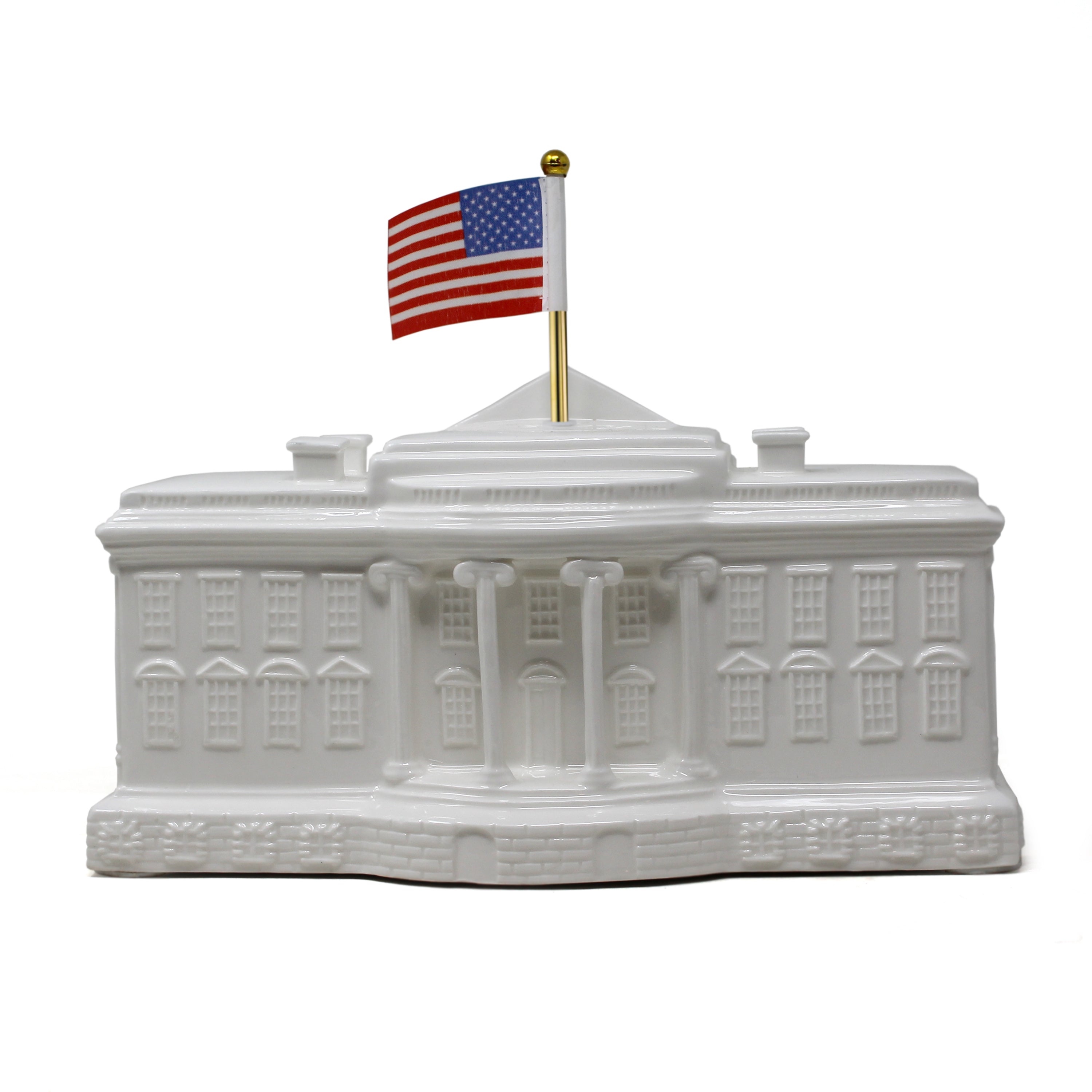 Front view of White House shaped porcelain piggy bank with American flag on gold-tone pole