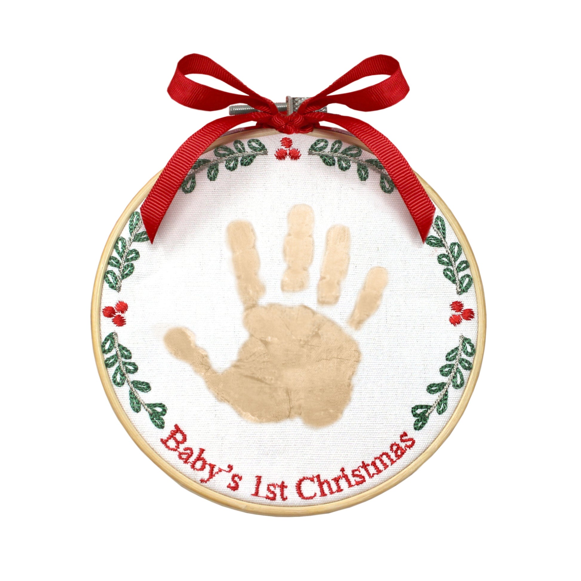 Close-up of baby handprint ornament with gold handprint on white embroidered canvas and red bow ribbon