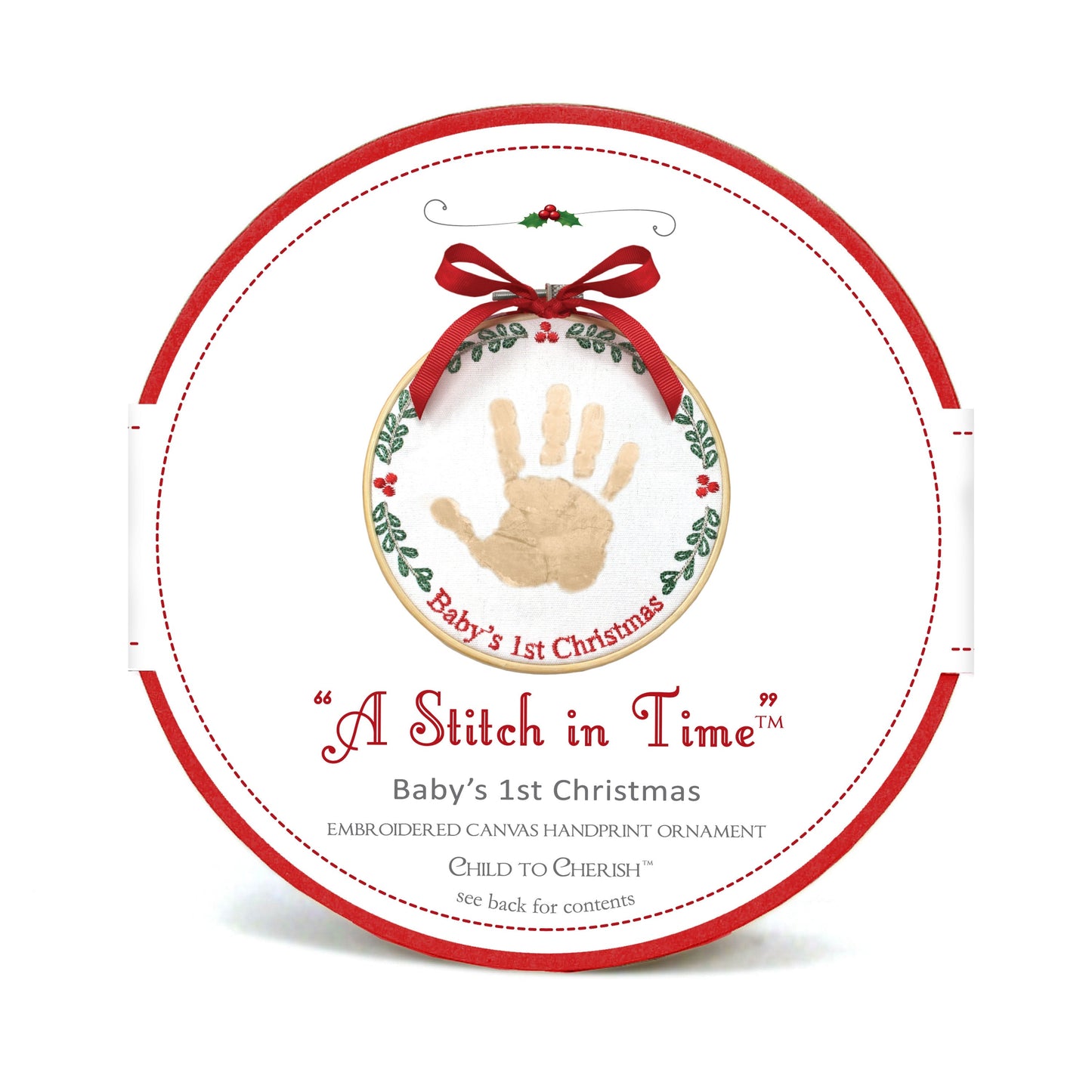 Packaging of A Stitch in Time Baby's 1st Christmas handprint ornament showing wood hoop and embroidered canvas with gold handprint and red ribbon