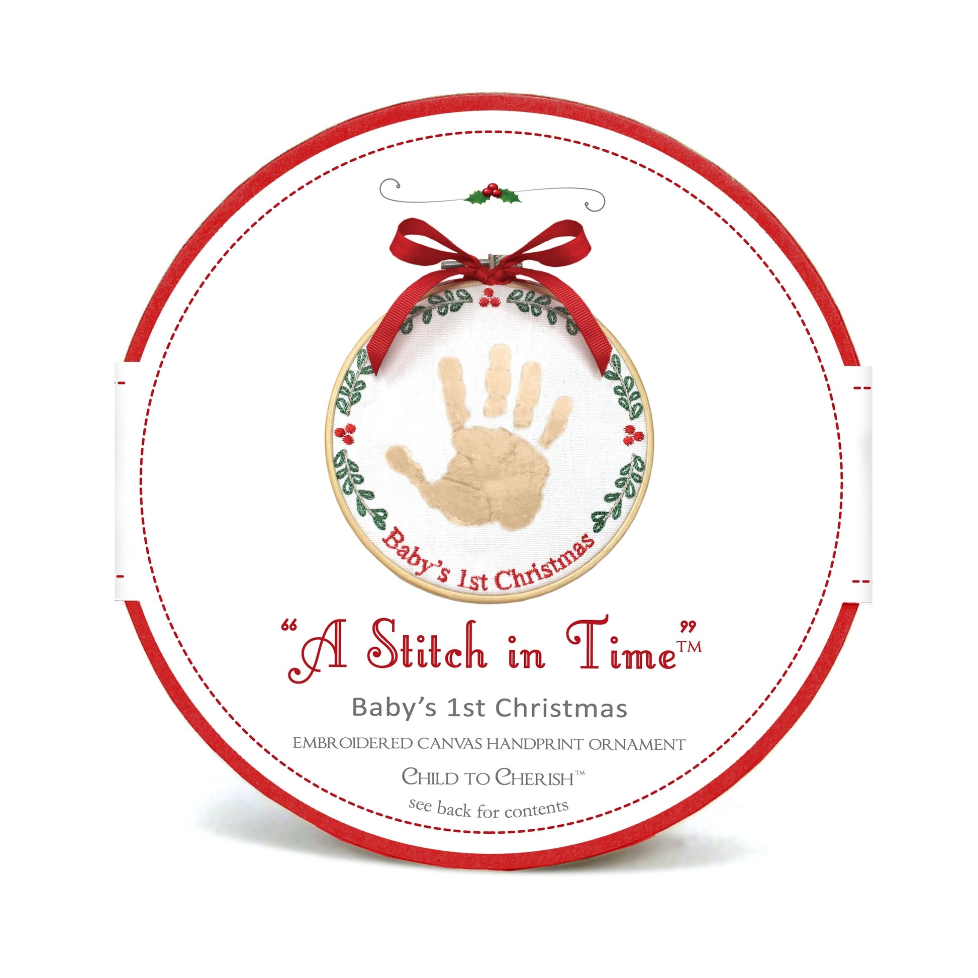 Packaging of A Stitch in Time Baby's 1st Christmas handprint ornament showing wood hoop and embroidered canvas with gold handprint and red ribbon