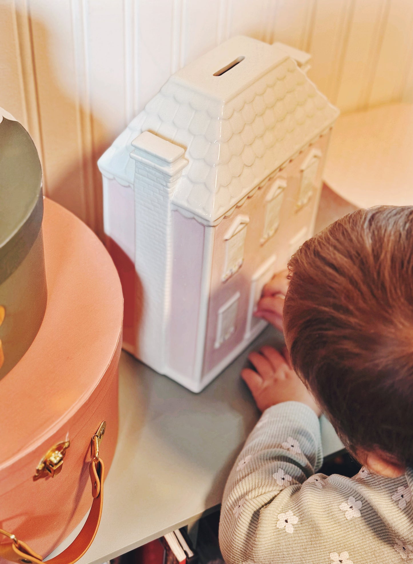 Top and side view showing white tiled roof and chimney of Dolly’s House piggy bank