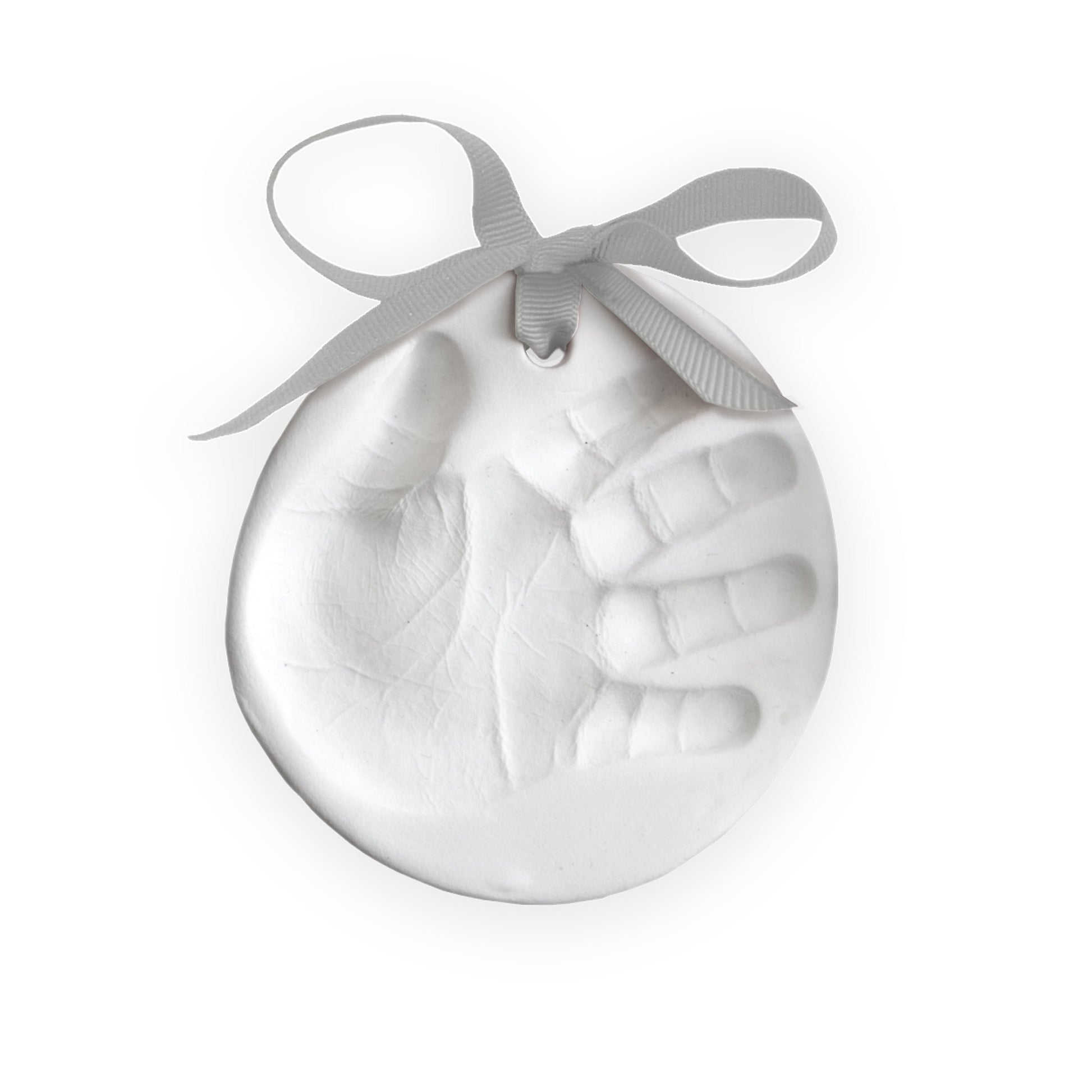 Close-up of a finished white clay handprint ornament with a gray ribbon tied at the top