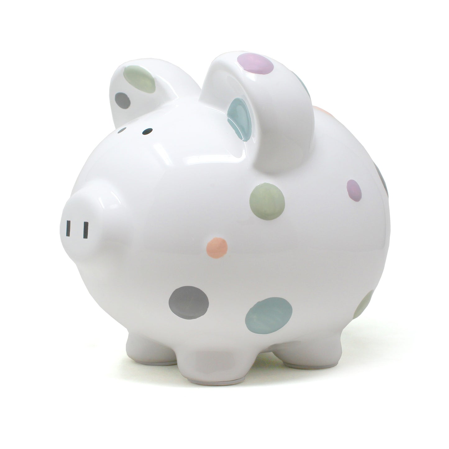 Side view of pastel polka dot piggy bank showing painted dots on glossy ceramic surface