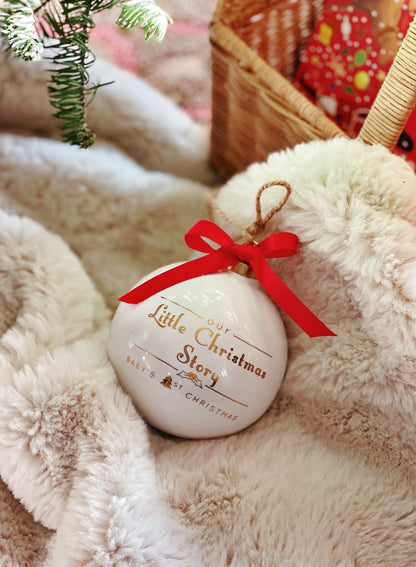 Porcelain ornament nestled in soft plush fabric and Christmas basket with red ribbon on top