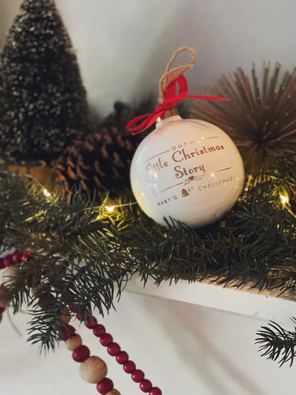 Porcelain Christmas ornament hanging on greenery with pine cones and red beaded garland background