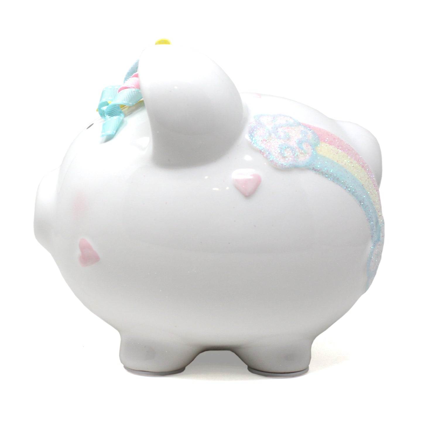 Angled view displaying pink unicorn face and ribbon curls on ceramic piggy bank