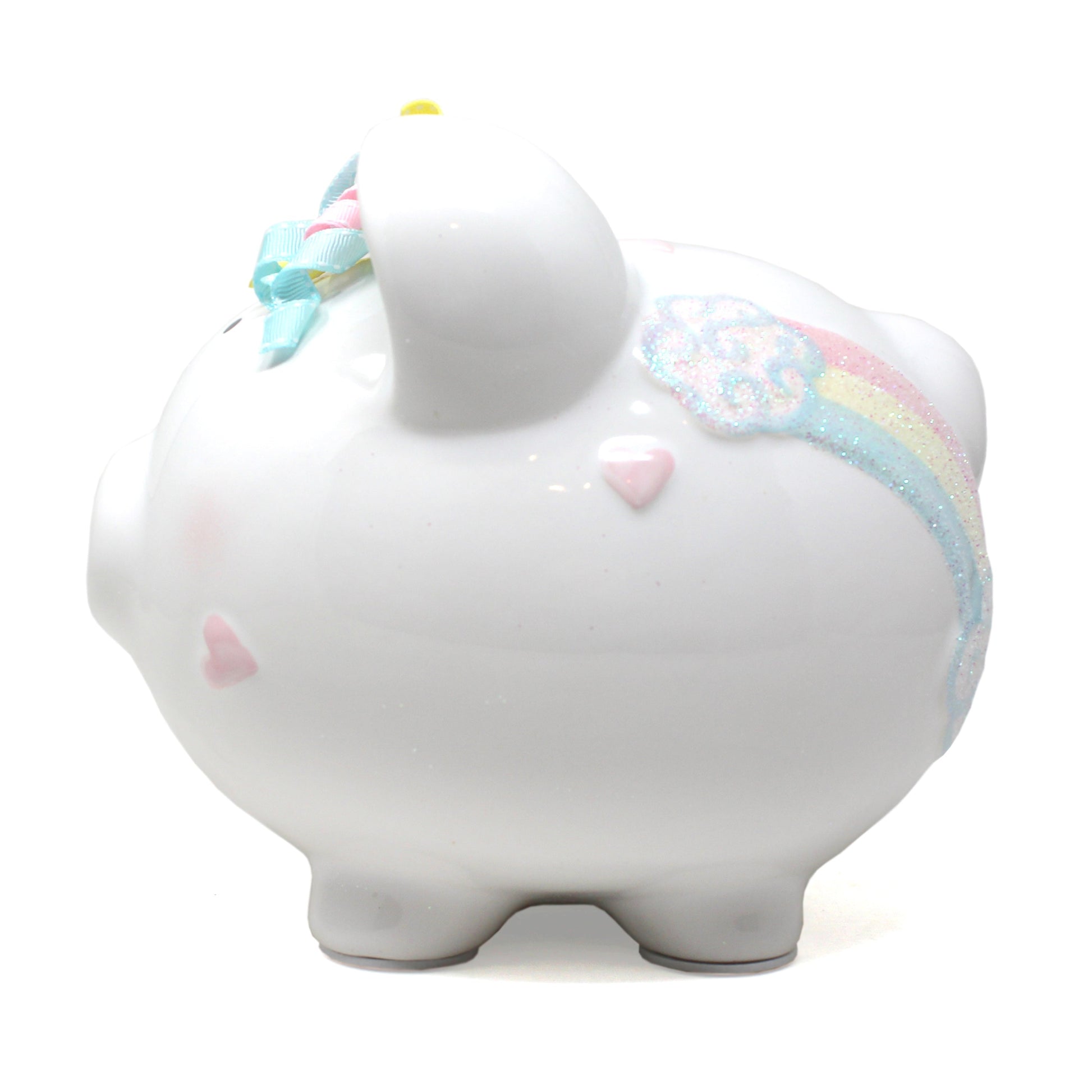 Angled view displaying pink unicorn face and ribbon curls on ceramic piggy bank
