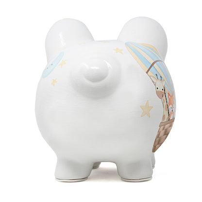 Back view of white piggy bank showing stars on ears and moon illustration