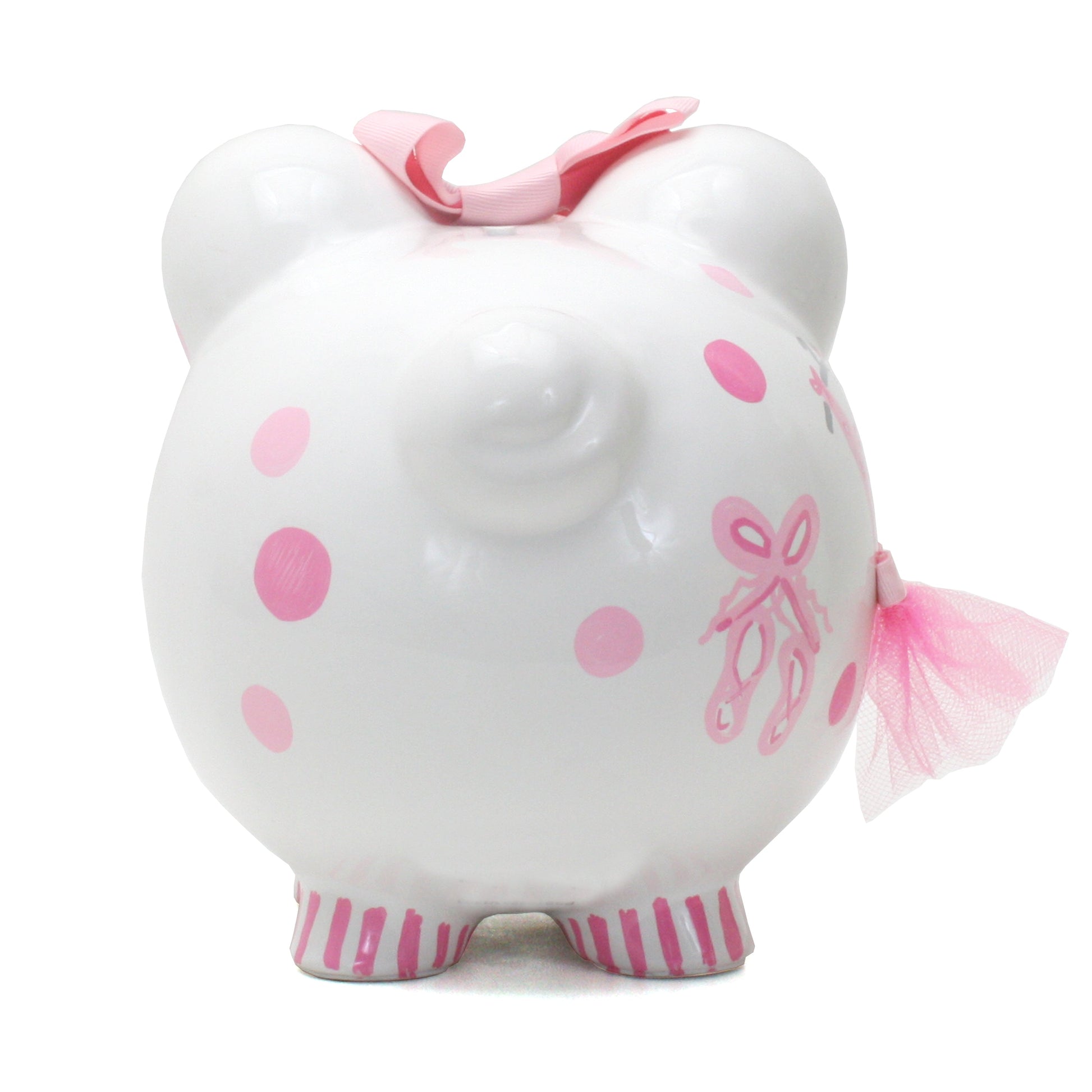 Back view of white piggy bank with pink polka dots and ballet slippers painted, showing the piggy bank’s rounded shape and striped pink feet