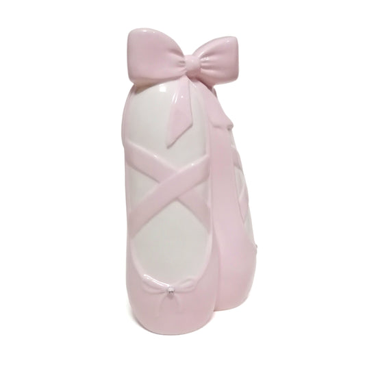 Ceramic ballerina slippers piggy bank in soft pink with decorative bows and crossed straps