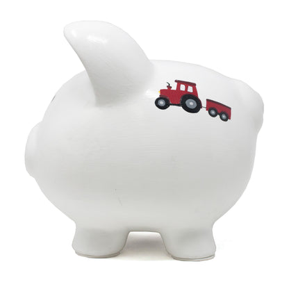 Top view of white ceramic piggy bank displaying coin slot and painted barnyard scenes on sides