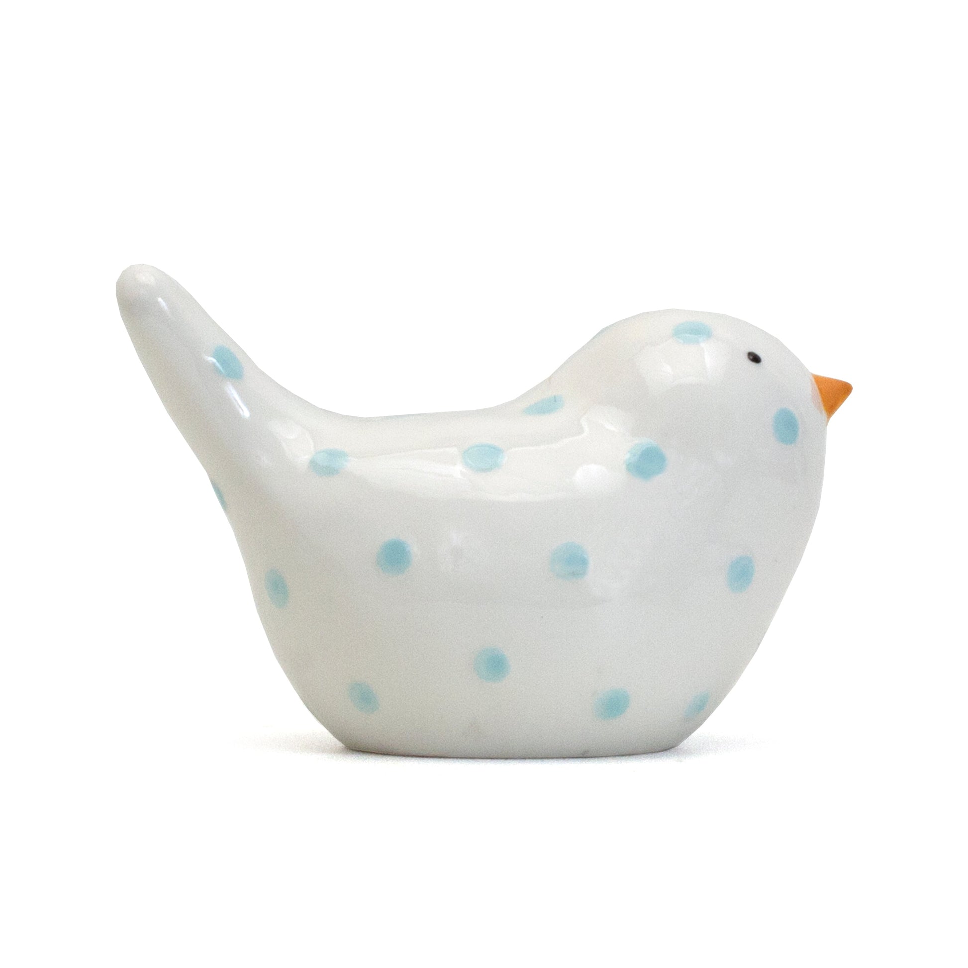Side view of handpainted white ceramic bird with blue dots and orange beak money slot