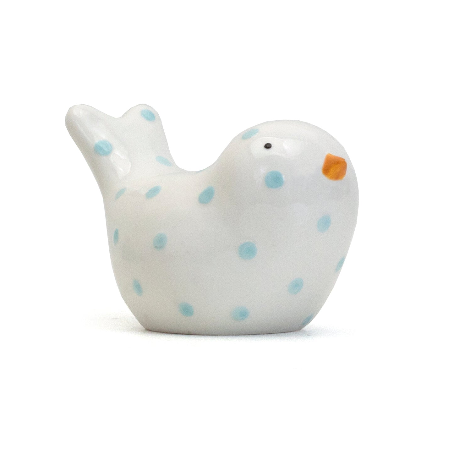 Front left view of small white ceramic bird bank with blue polka dots and orange beak
