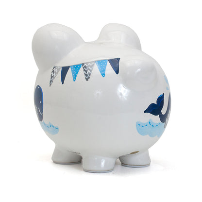 Left rear angle of piggy bank highlighting handpainted whale and waves