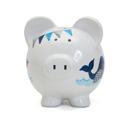 Front view of piggy bank featuring coin slot and whale illustration