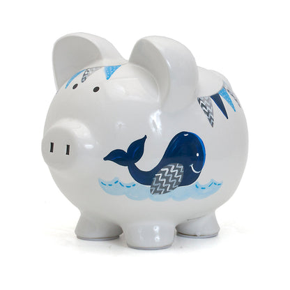 Left side view of piggy bank with deep blue whale and banner decoration