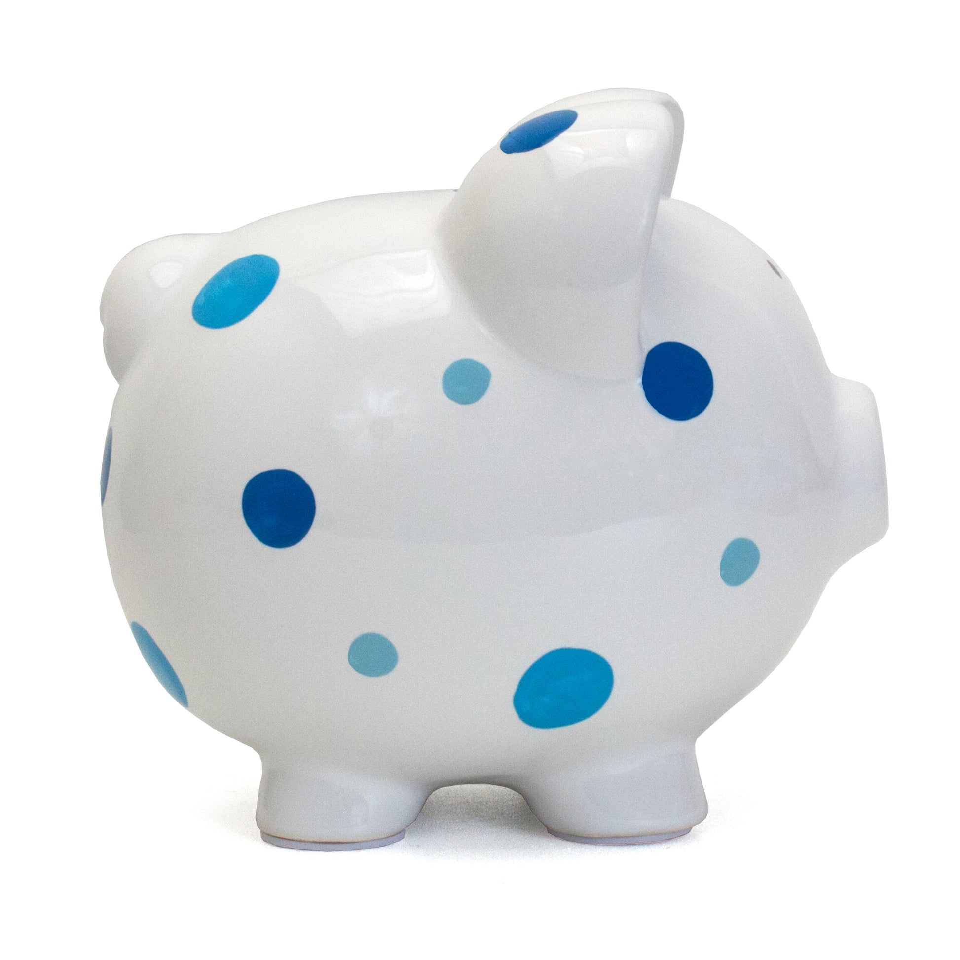 Side view of white piggy bank with blue polka dots showing rounded shape