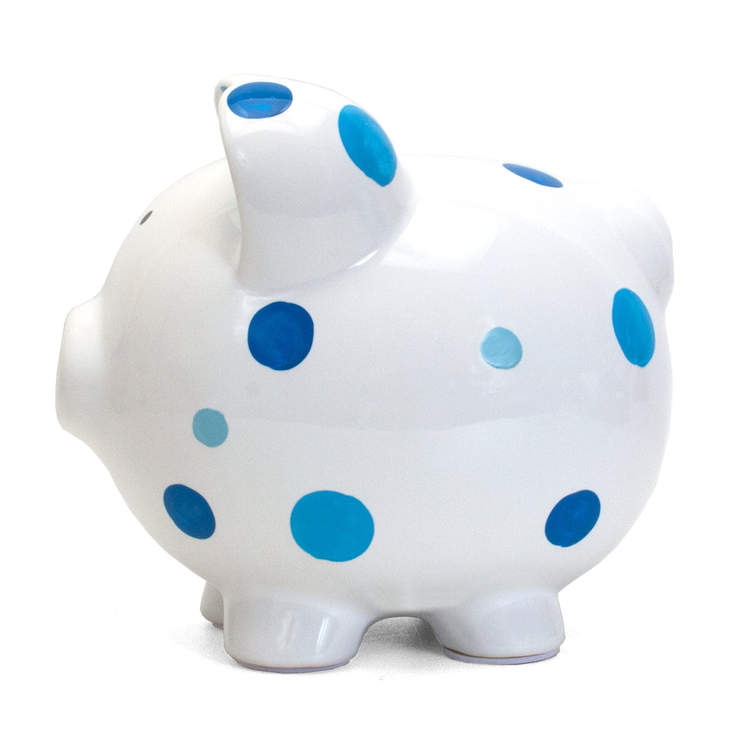 Opposite side view of white ceramic piggy bank with blue polka dot design