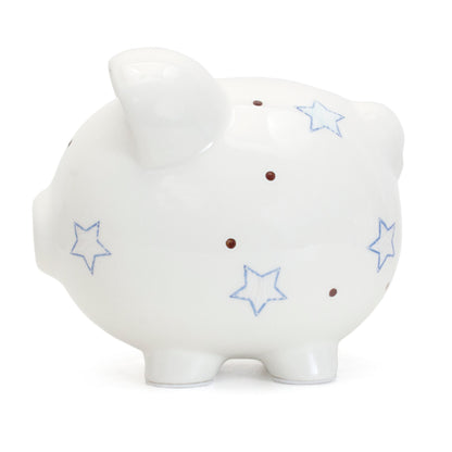 Top view showing coin slot on white piggy bank decorated with blue and brown dots