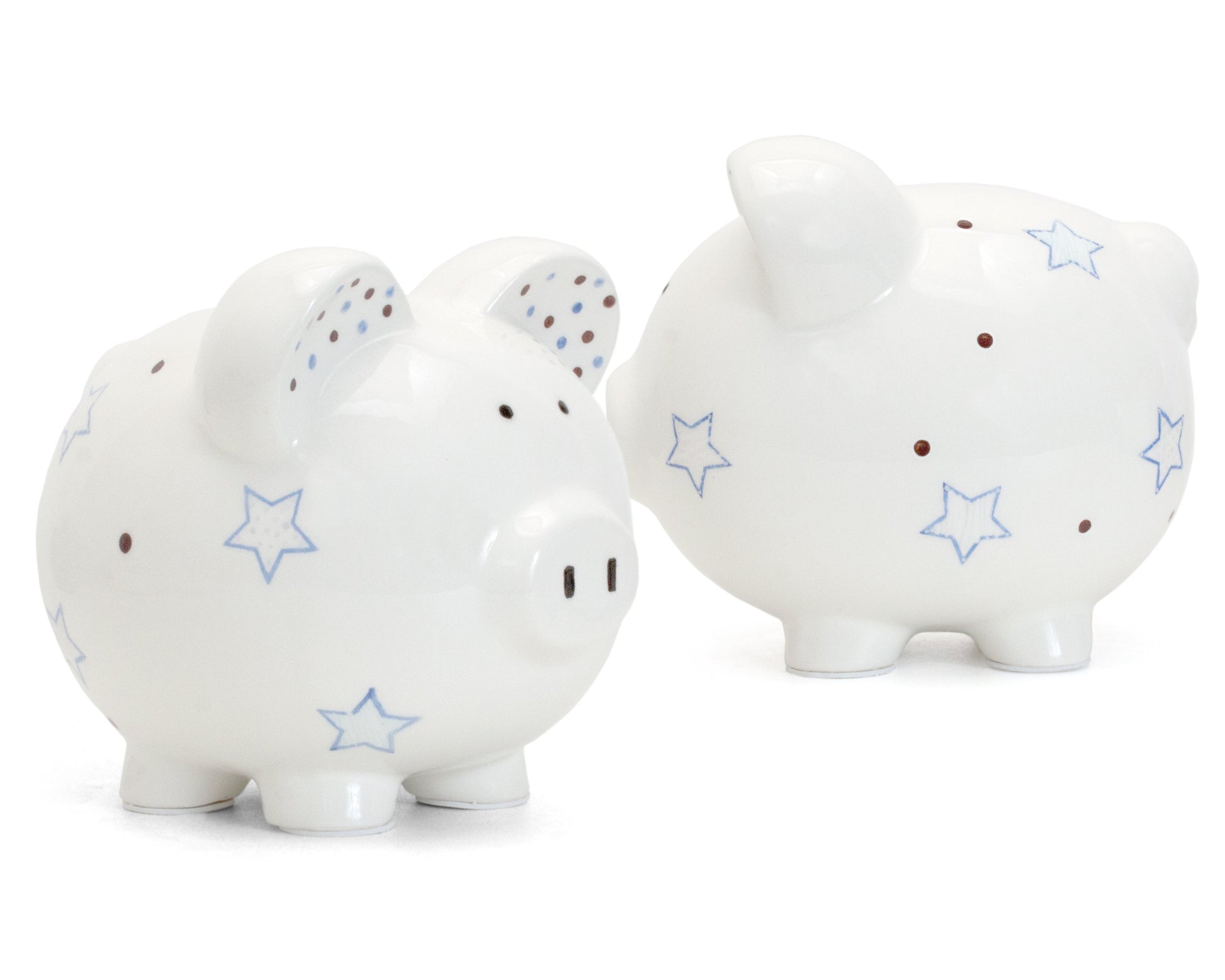 Two white ceramic piggy banks with blue star and brown dot design side by side